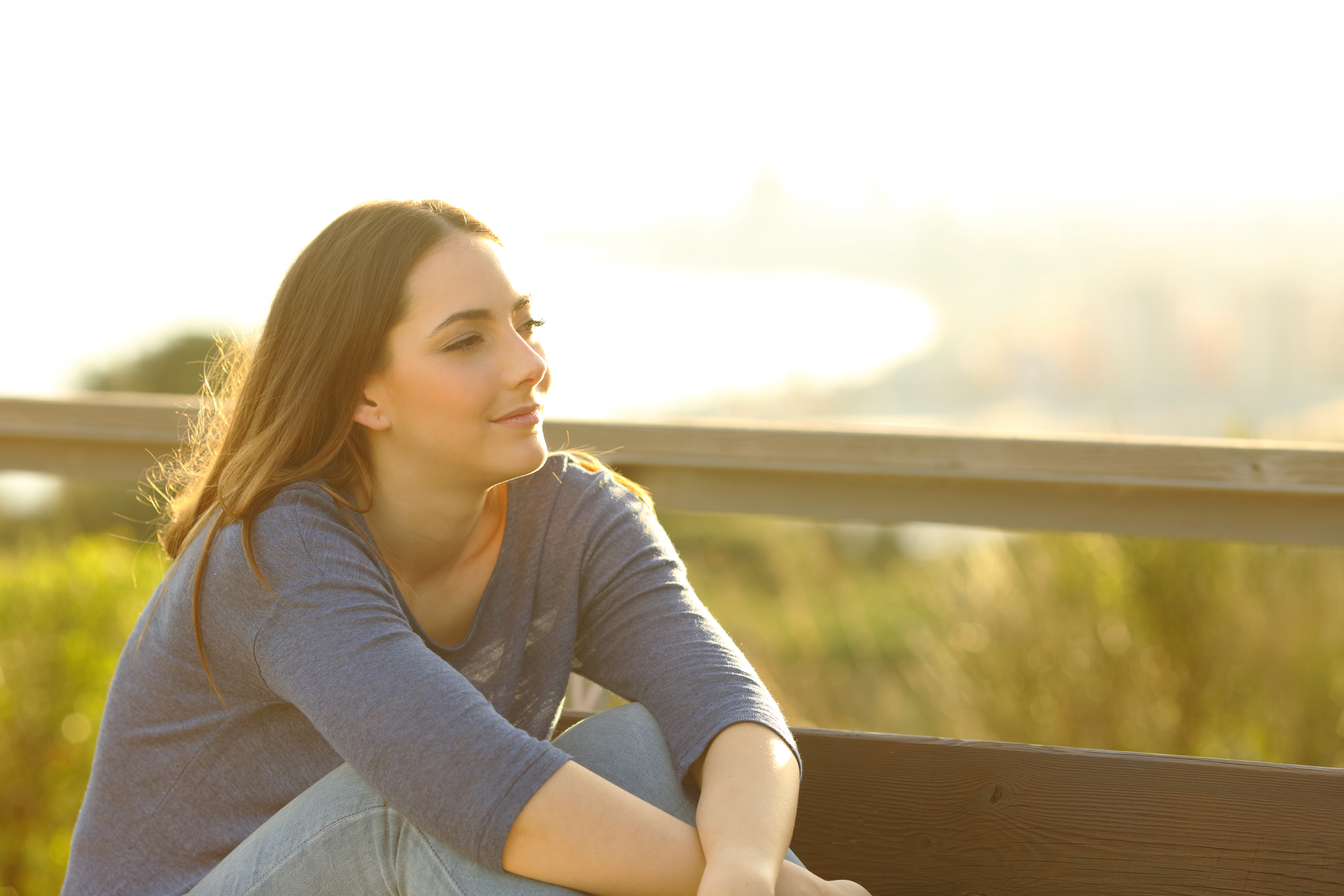 Young lady looking into distance deep in thought