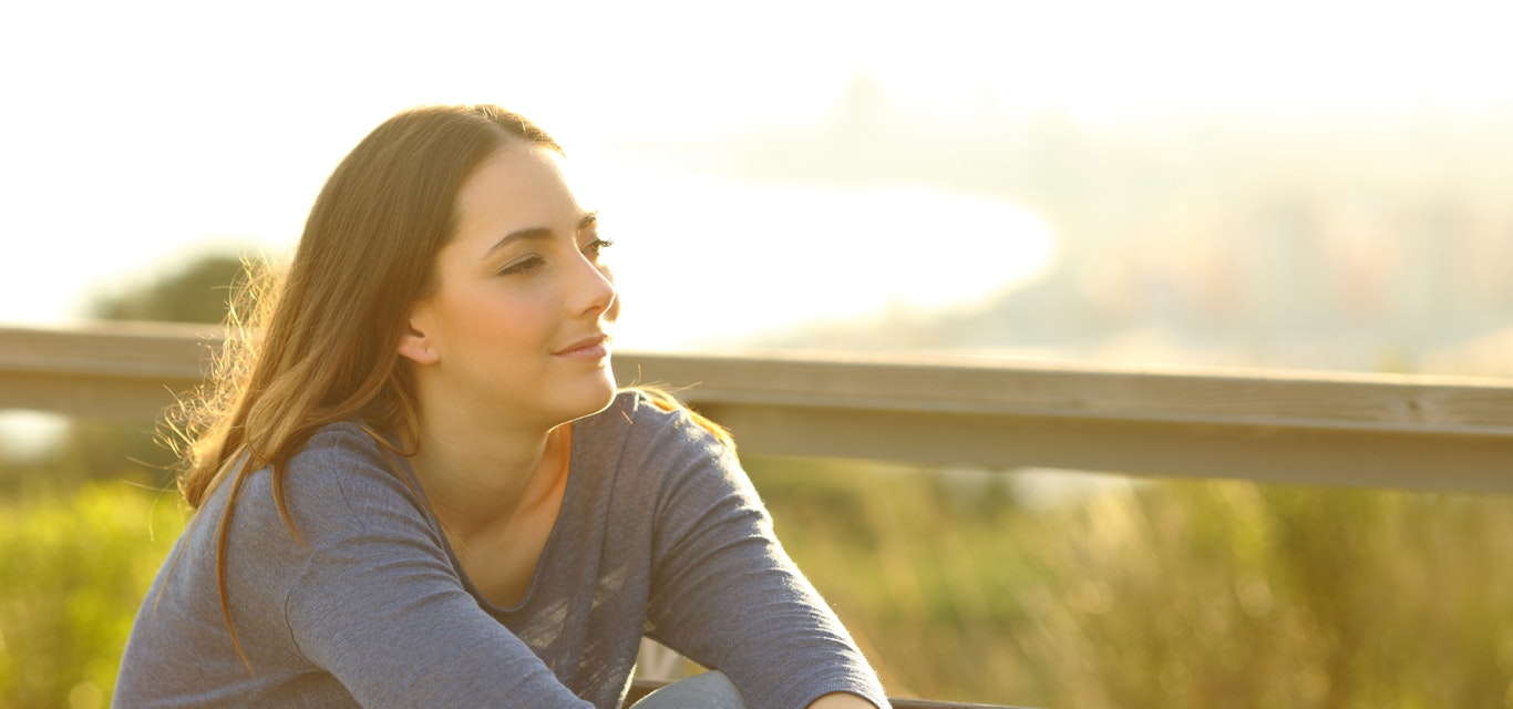 Young lady looking into distance deep in thought