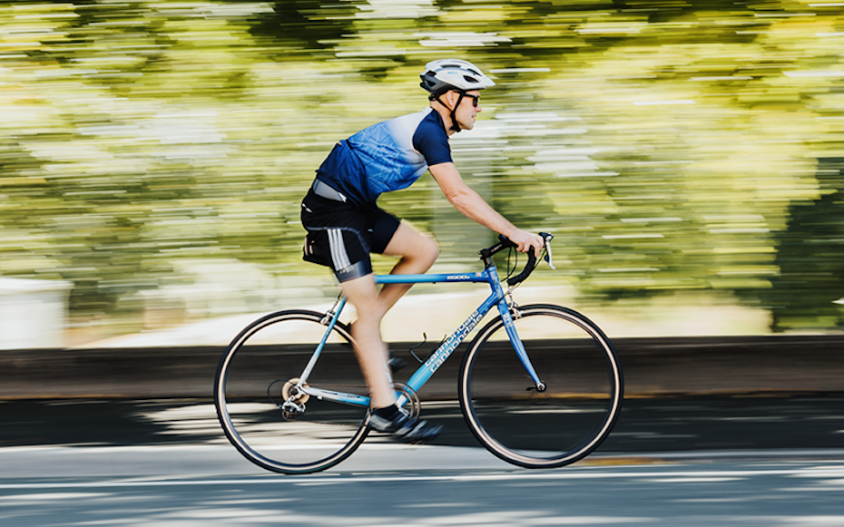 Man riding bike along road