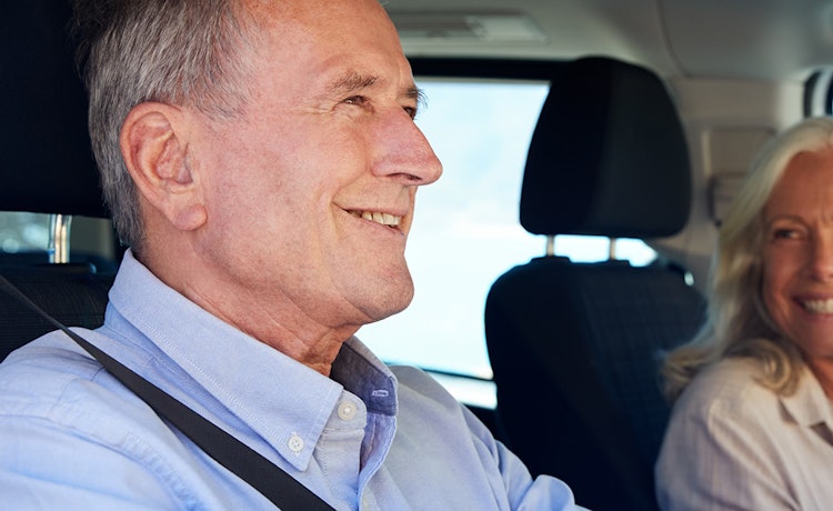 Man driving as woman smiles in passenger seat