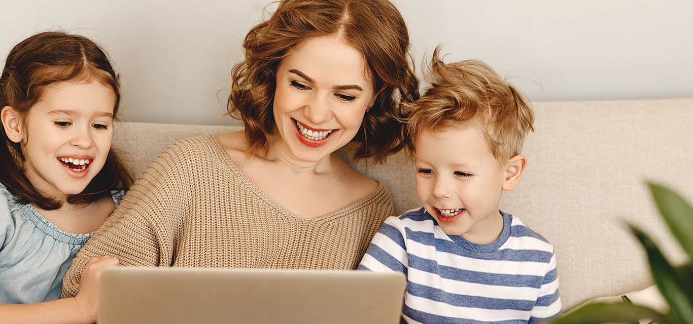 Learning together Mum and kids sitting around a laptop