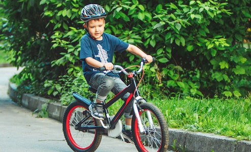 Young boy riding a small BMX bike