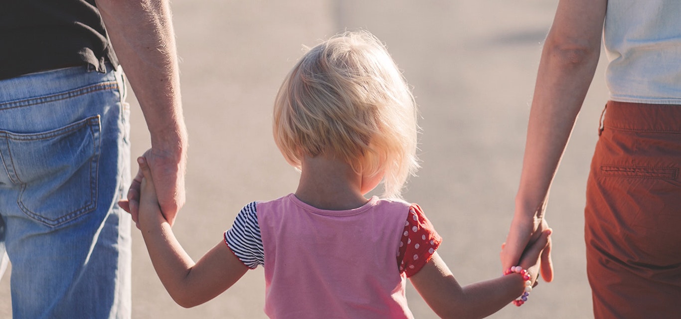 Child walking with parents