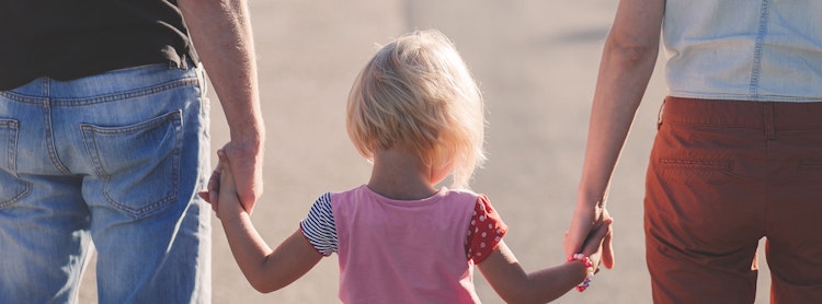 Child walking with parents