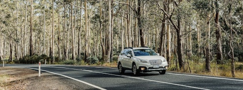 White car driving on road