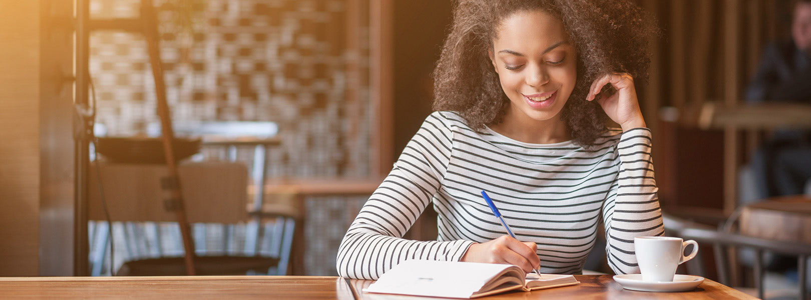 Person writing in their notebook.