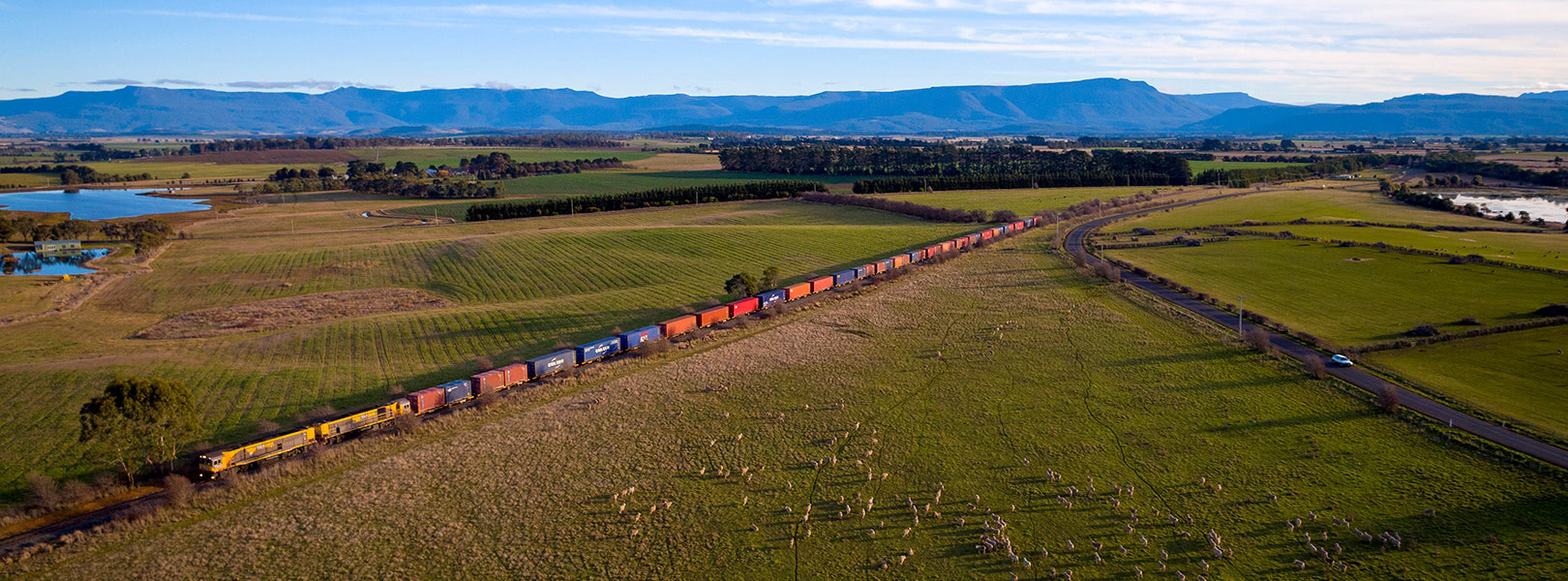 TasRail train crossing rural Tasmania