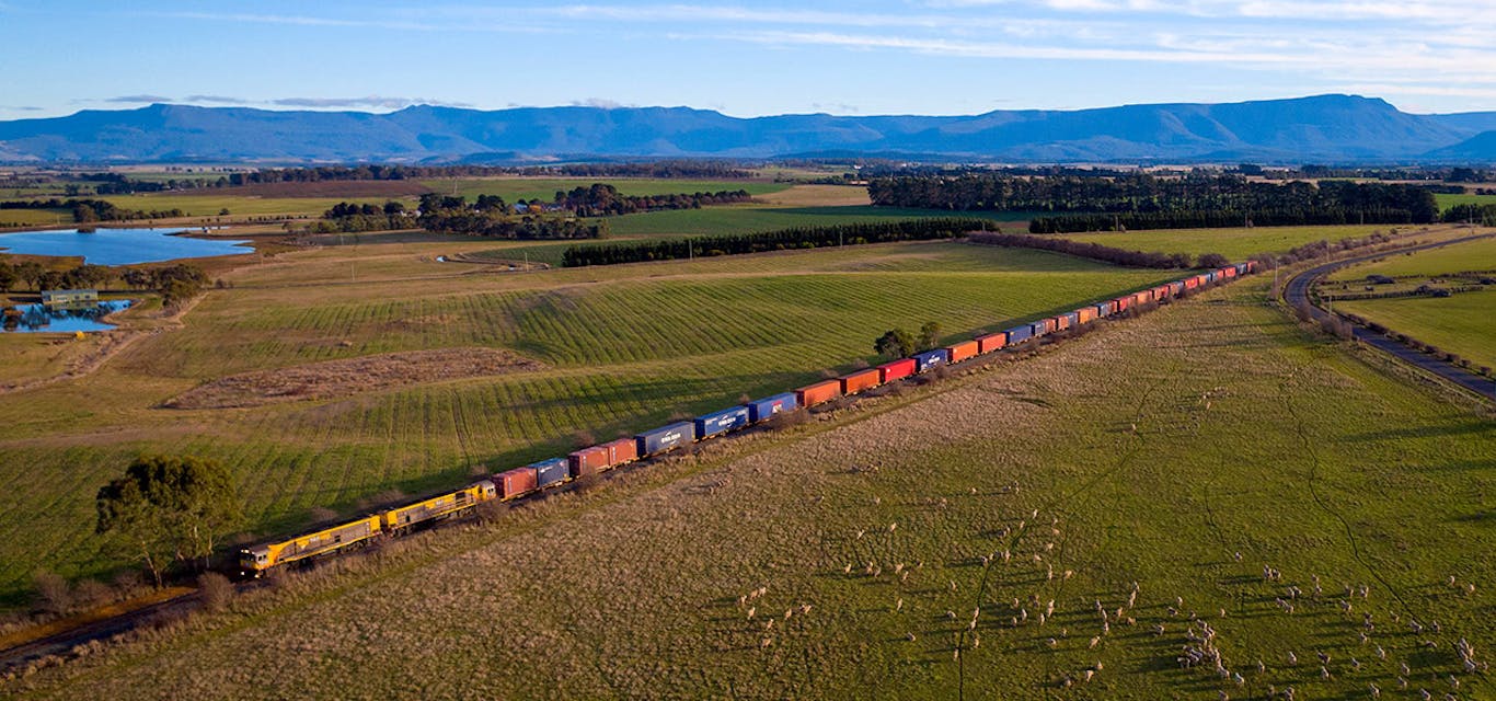 TasRail trains operate across Tasmania TasRail train crossing rural Tasmania