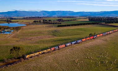 TasRail train crossing rural Tasmania