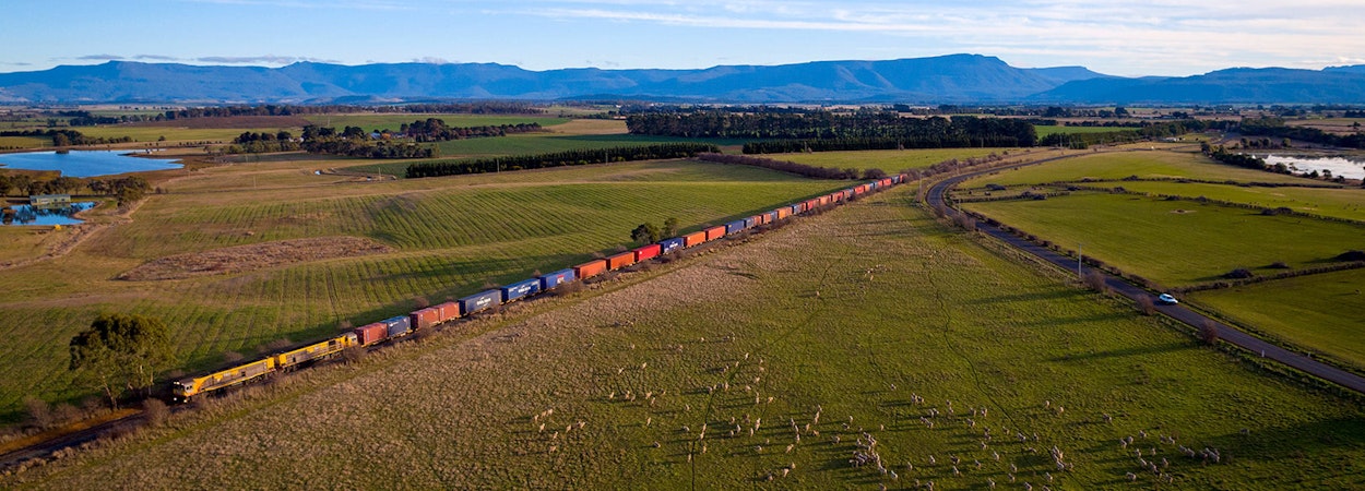 TasRail train crossing rural Tasmania