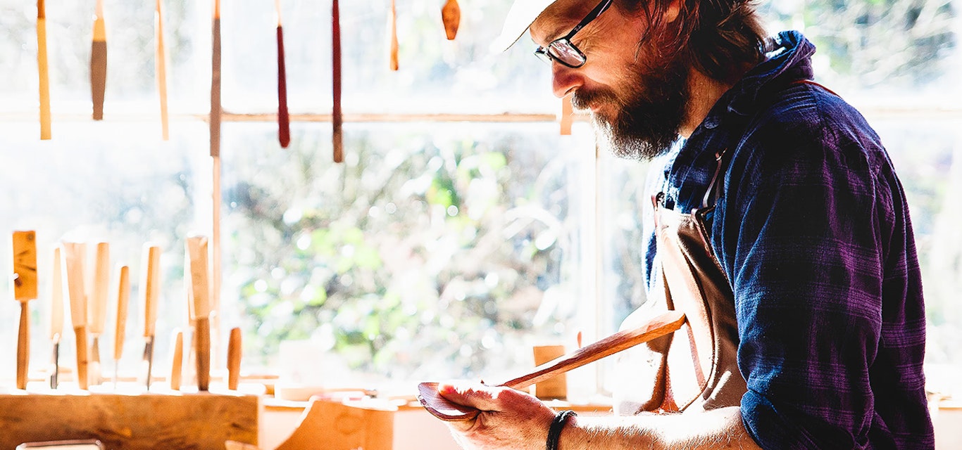 David Rauenbusch has carved out a career in Cygnet with his handmade spoons. Craftsman oiling his finished wooden spoon