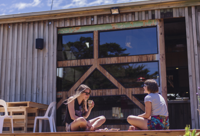 Two people sitting outside Willie Smiths Apple Shed