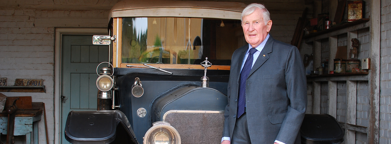 Man standing in front of vintage car