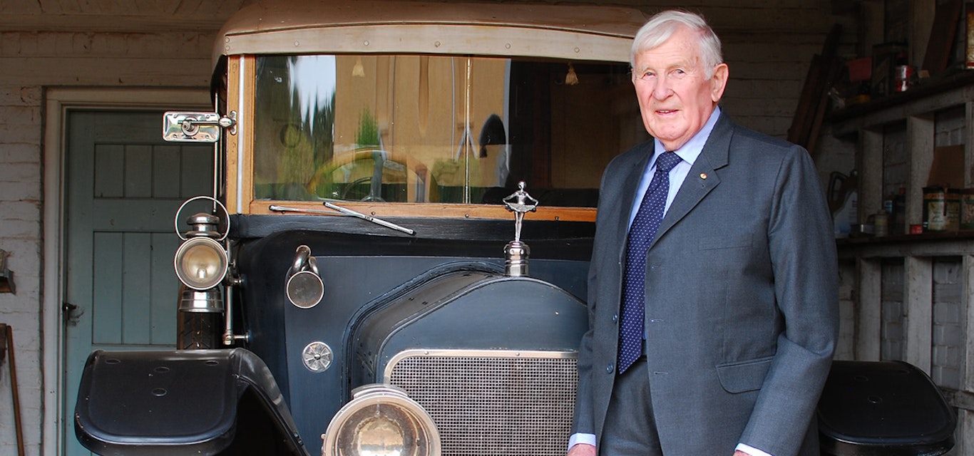 Woolmers Estate Chair Peter Rae with the Wolseley 'Town Tourer'. Man standing in front of vintage car