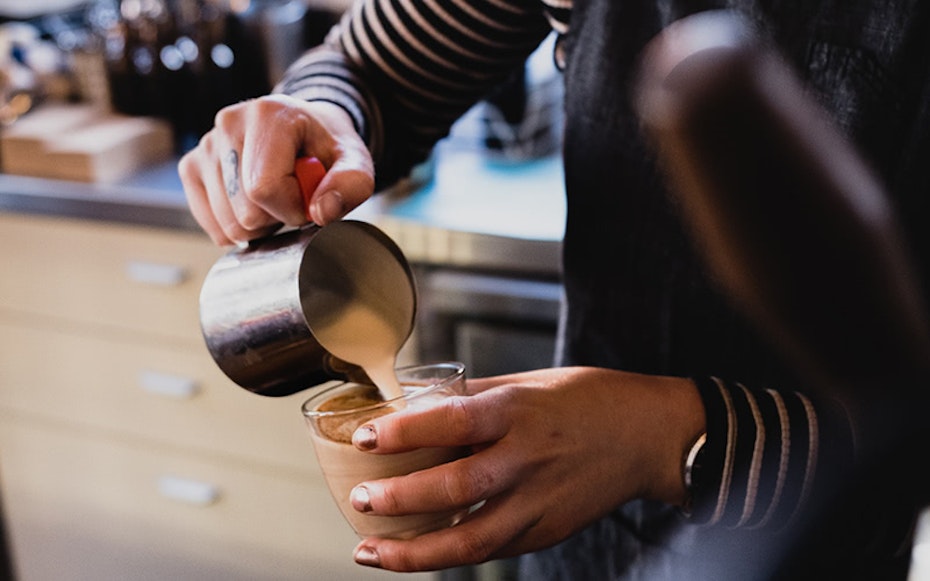 Person making coffee at The Chapel