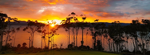 Sunrise peaking over the hills on a wintery morning making the sky red