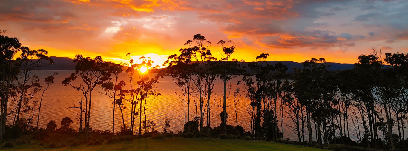 Sunrise peaking over the hills on a wintery morning making the sky red