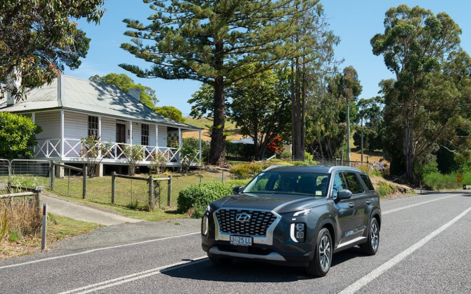 Hyundai Palisade driving down country road