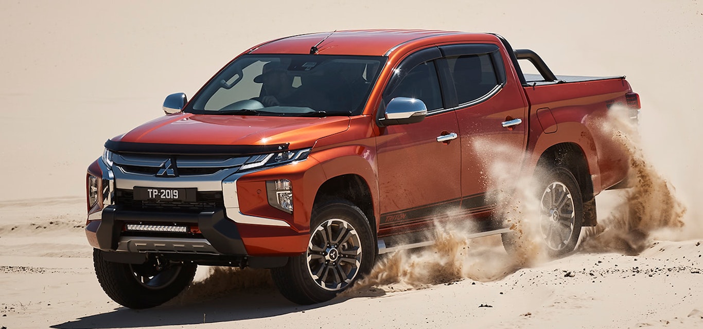 Mitsubishi Triton driving on sand