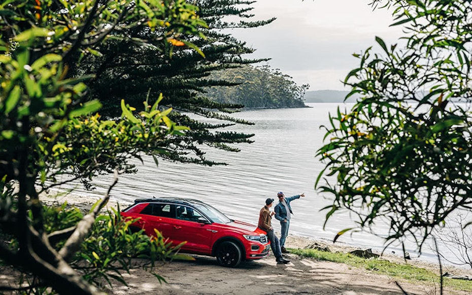 Car parked at water's edge.