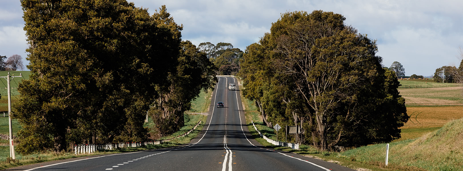 A truck coming down a rural highway