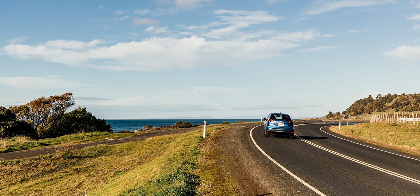 Car driving on scenic coastal road