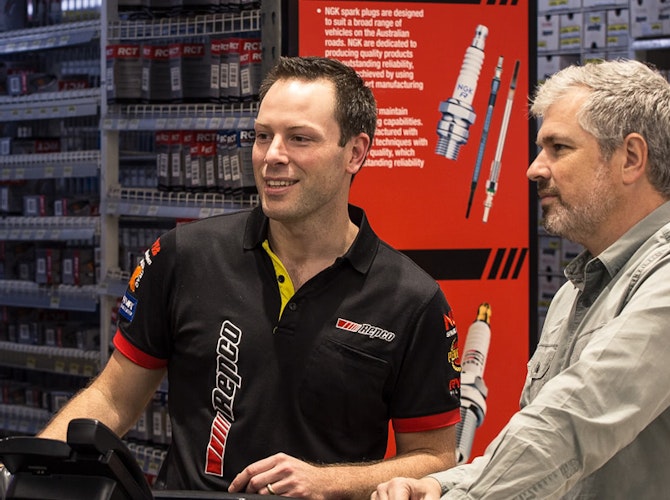 Repco store assistant helping a customer