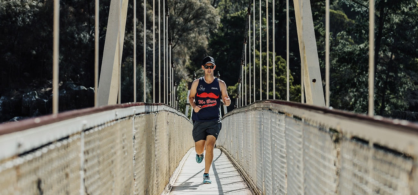 Man running over bridge 