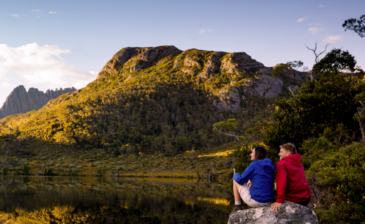 Young couple looking over lake to Cradle Mountain