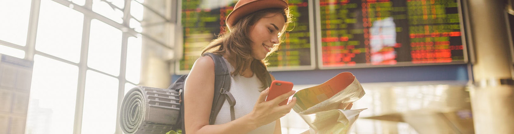 Young lady looking at map in airport