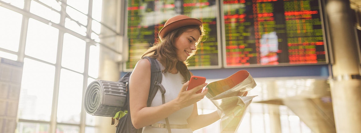 Young lady looking at map in airport
