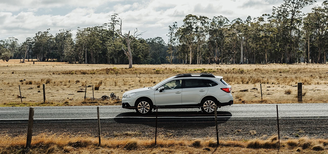 Subaru Outback driving along country road