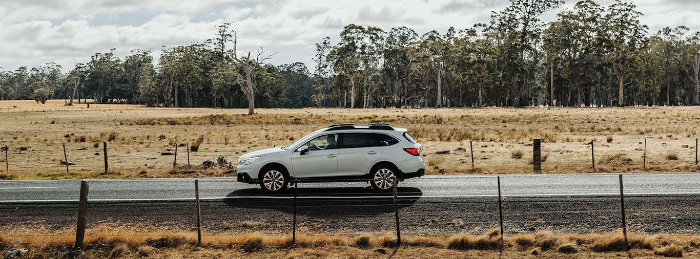 Subaru Outback driving along country road