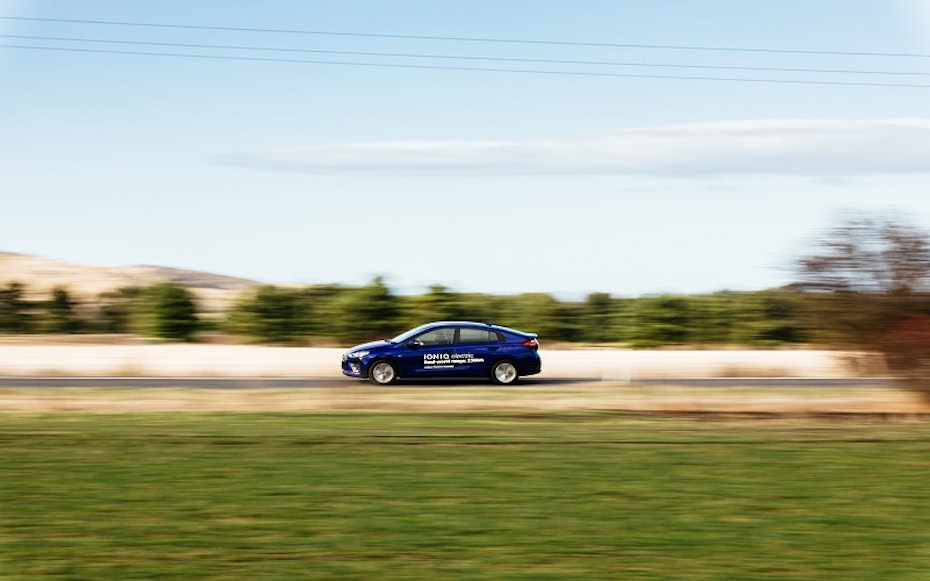 Hyundai Ioniq electric vehicle driving along rural road