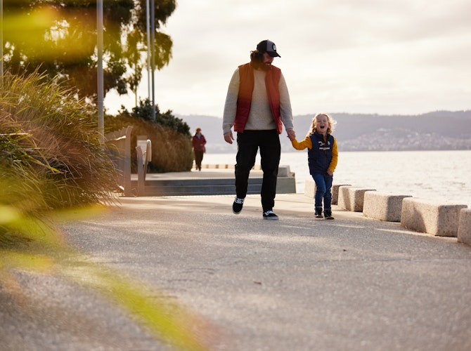 Dad and son walking on the esplanade