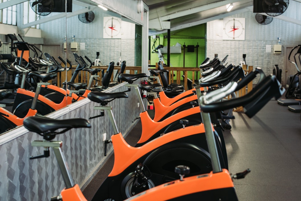 Orange exercise bikes in gym