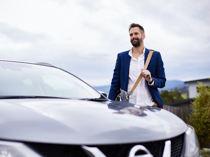 Man standing next to an SUV