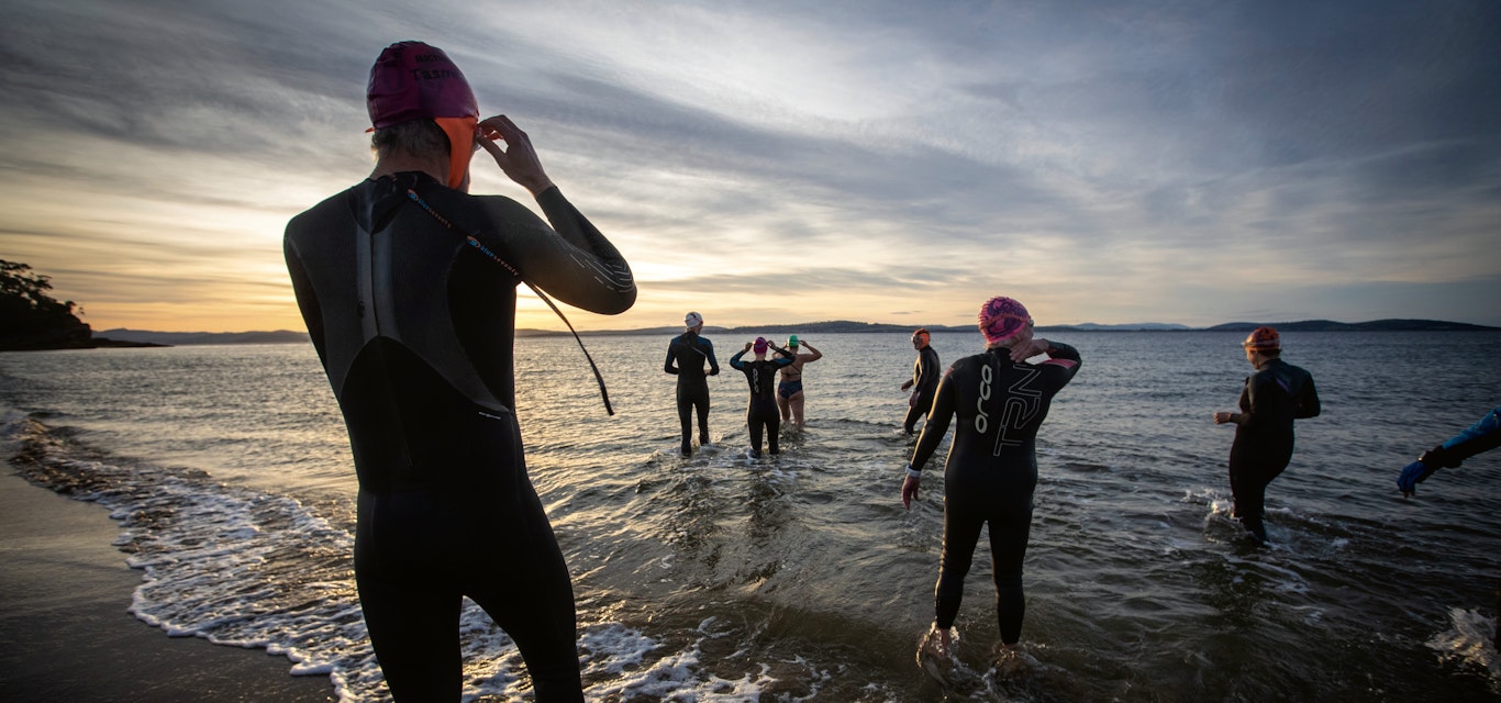 Swimmers braving the cold water swimmers entering the ocean