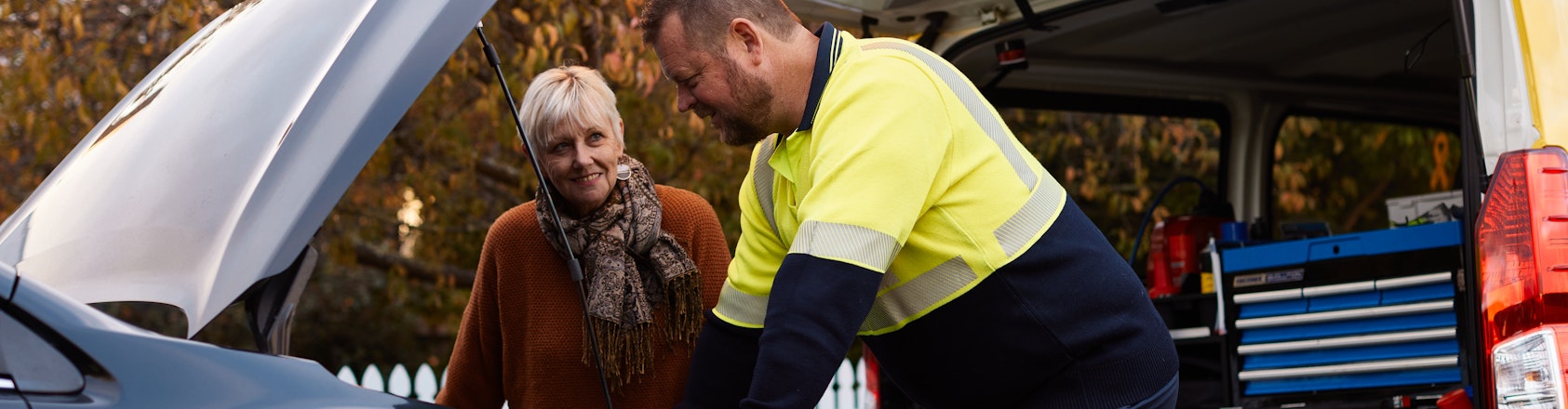 Roadside patrol helping member on side of the road.