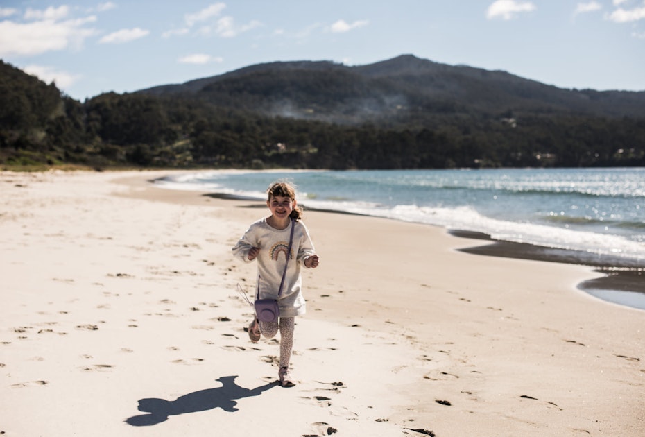 Child running along the beach