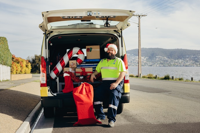 Santa with his roadside patrol van stocked with gifts.