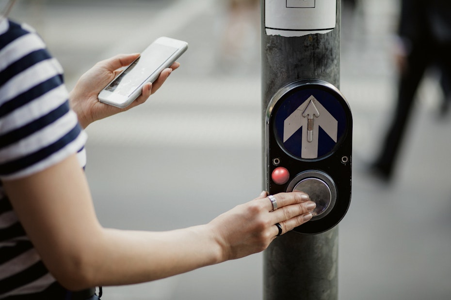 pedestrian hitting the crossing button