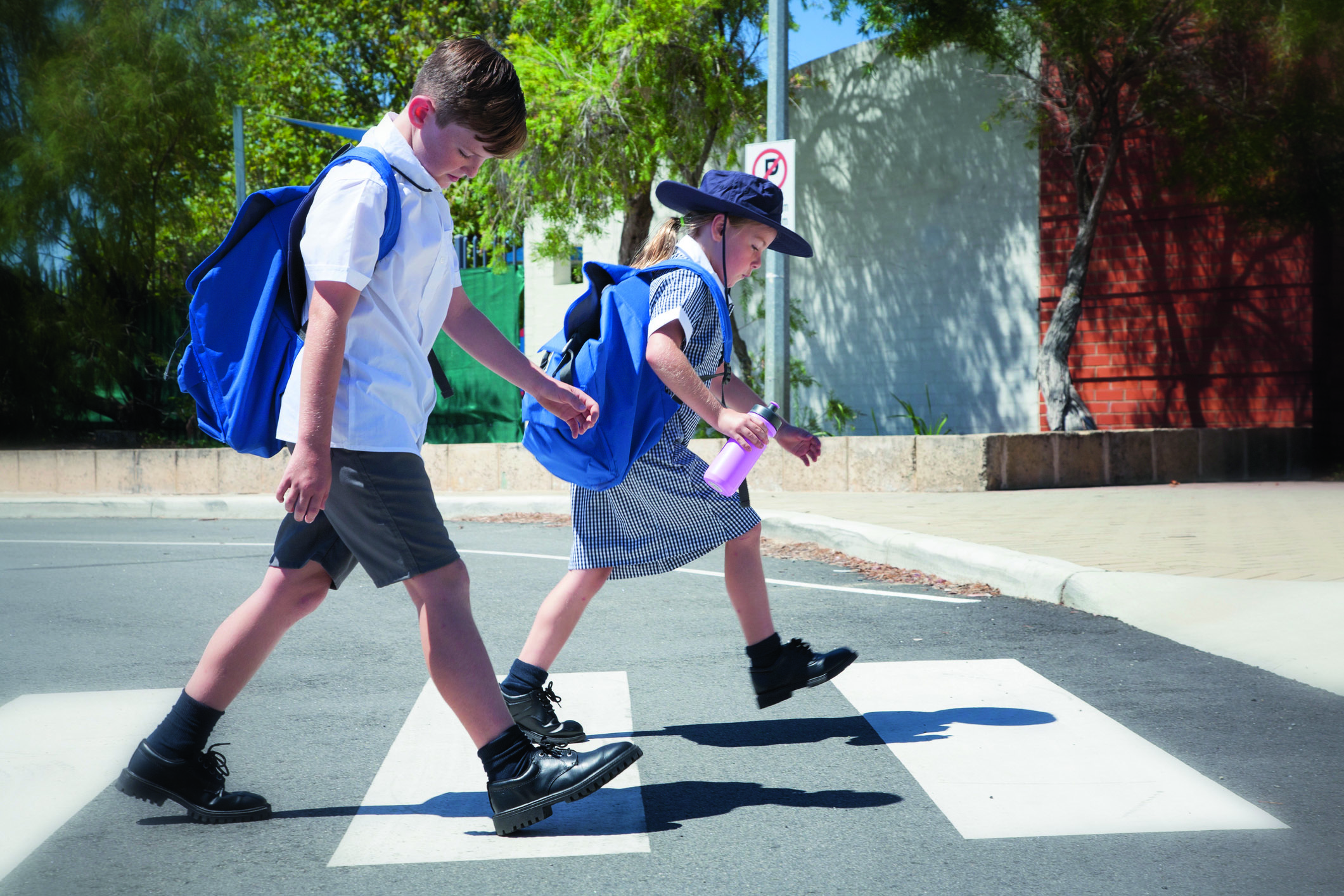 children crossing the road at a zebra crossing