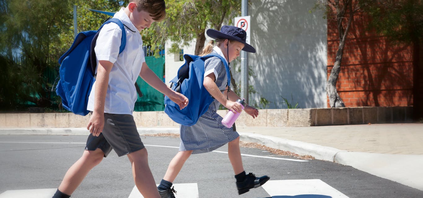 children crossing the road at a zebra crossing