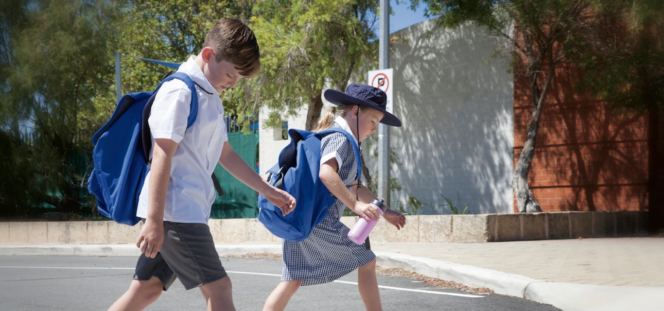 children crossing the road at a zebra crossing