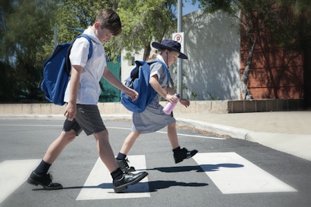 children crossing the road at a zebra crossing