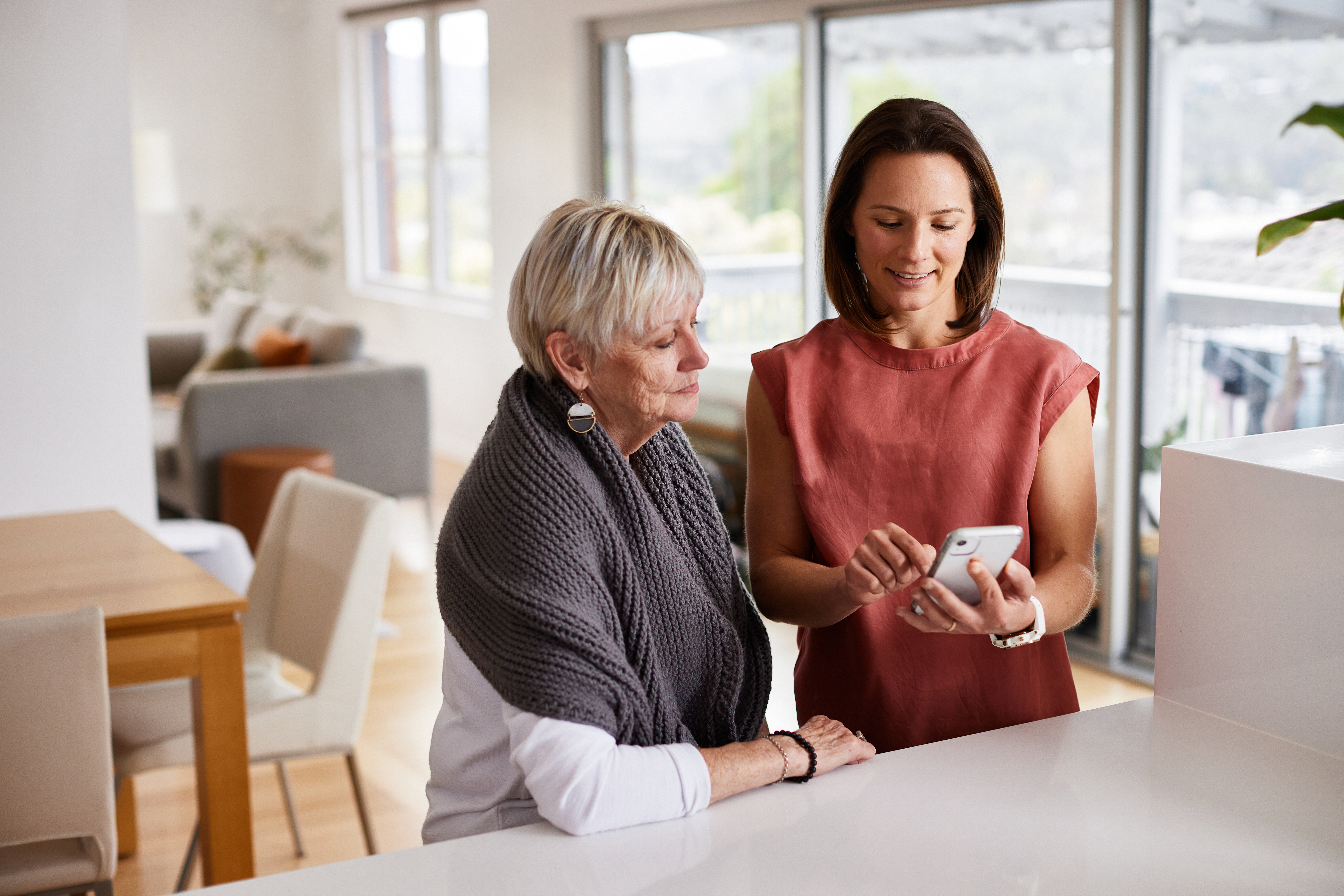 Ladies looking at mobile phone screen.