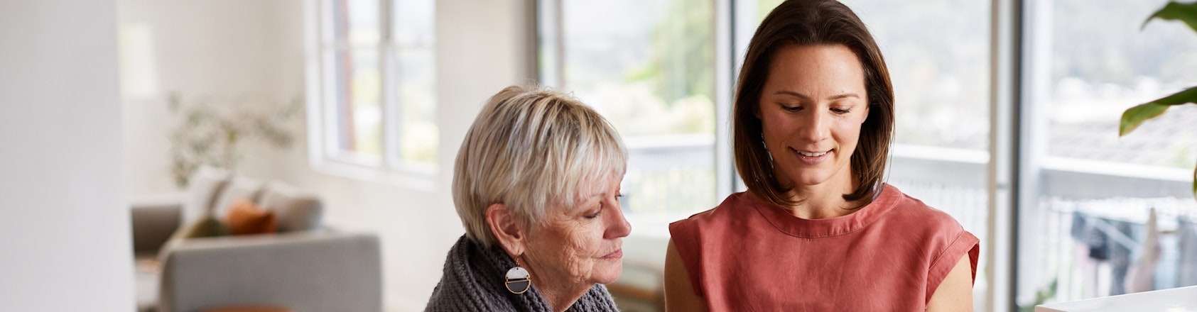 Ladies looking at mobile phone screen.