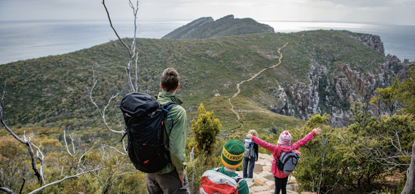 Hiking through Tasman National Park family walking on track