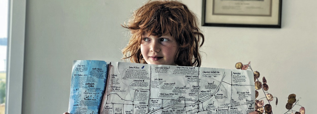 child holding hand drawn map